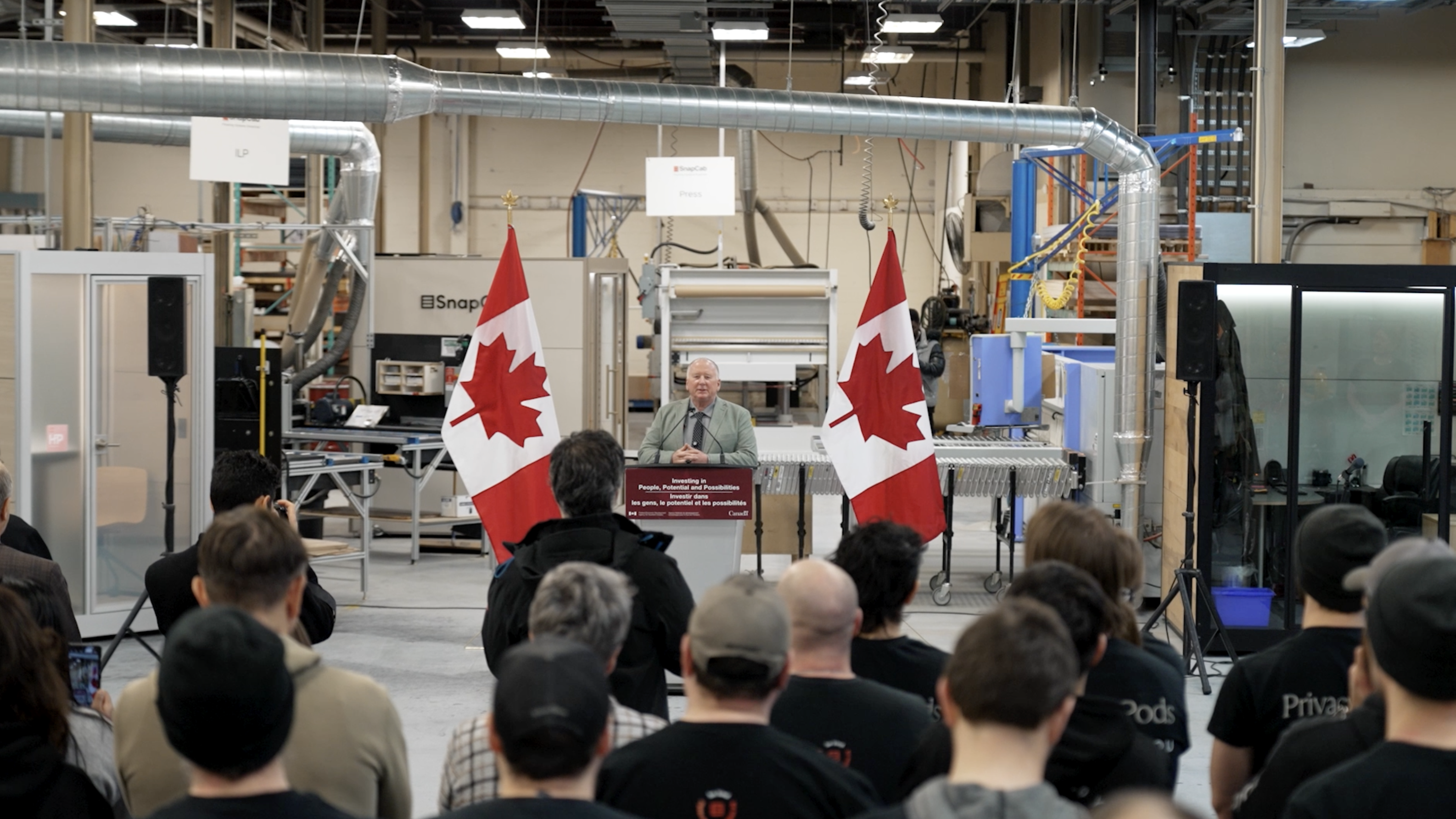 Corporate announcement event with Canadian flags filmed by ardist in Kingston